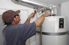 Jacob installs a new water heater in a residential utility room